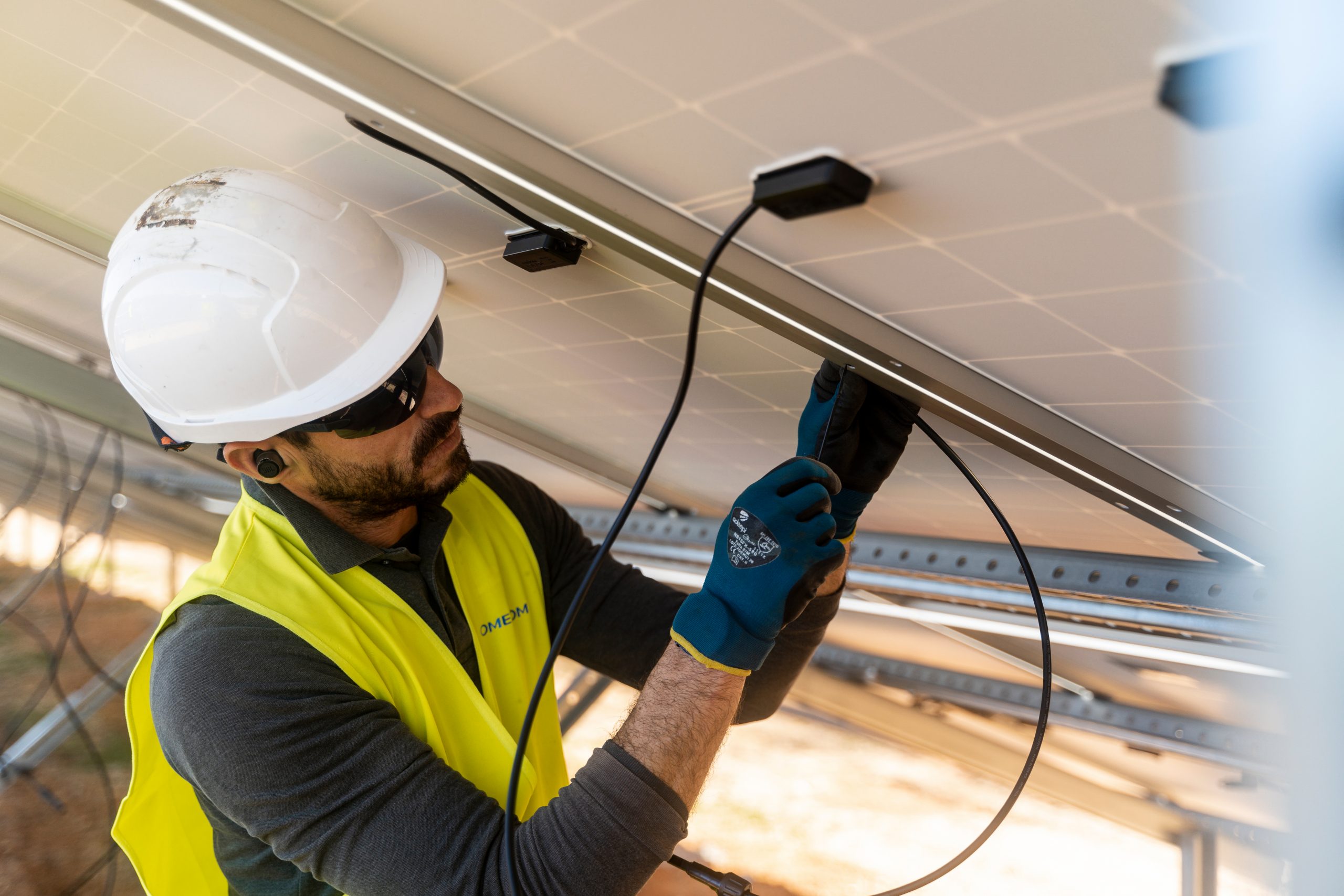 Omexom employee working on a solar panel