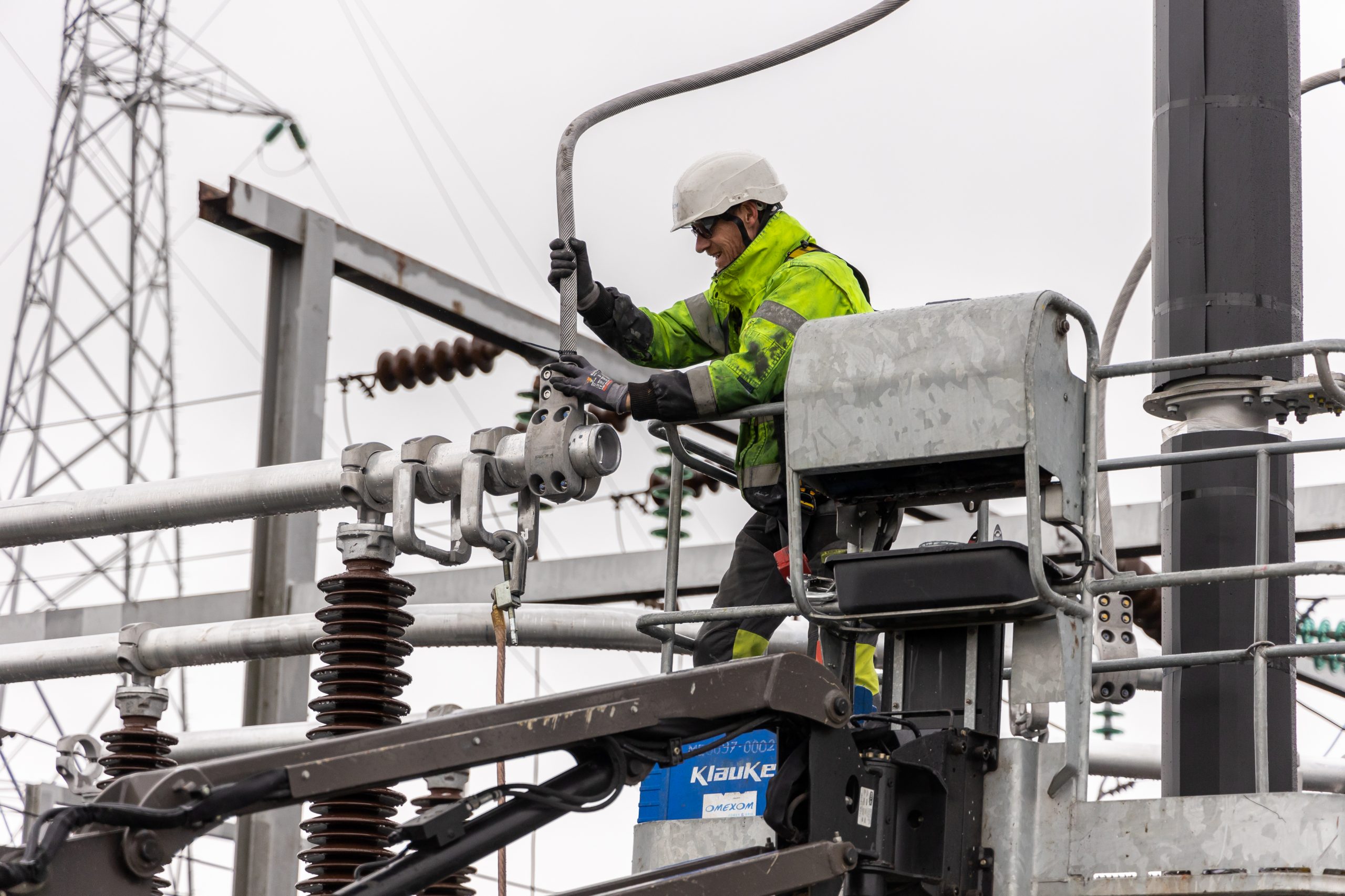 An Omexom employee working on the substation