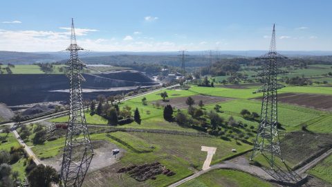 Omexom project photo of high-voltage infrastructure in a natural landscape