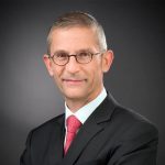 Corporate portrait of an energy industry executive in a professional business setting