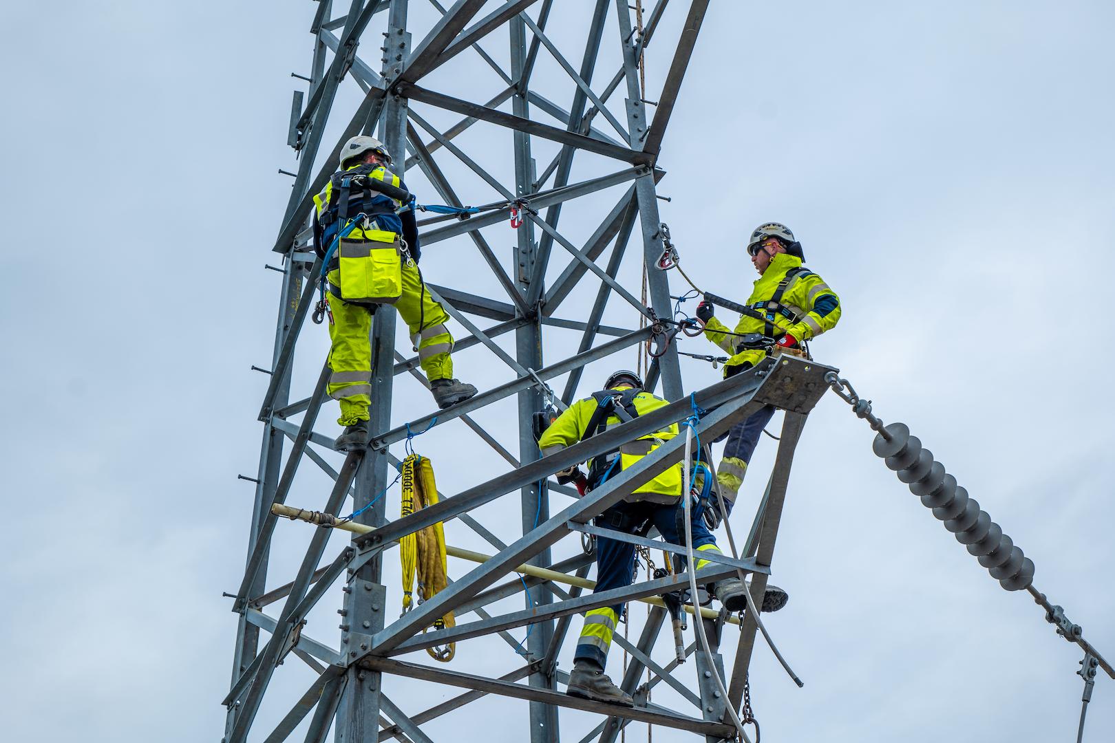 Highvoltage overhead transmission towers under a clear sky, carrying longdistance electricity lines