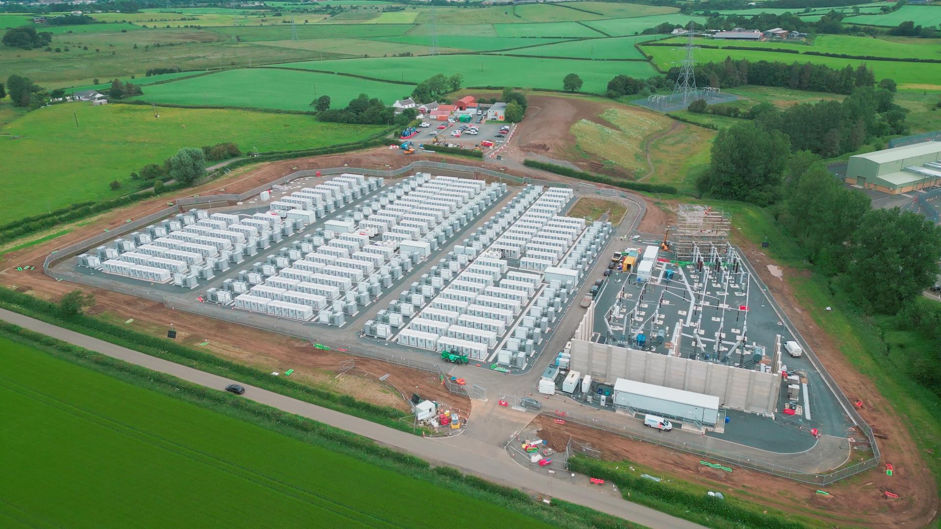 Aerial view of largescale electrical substation and underground transmission project surrounded by rural landscape in Scotland