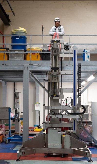 Precision industrial machinery used for reactor component handling and mechanical testing in a nuclear facility