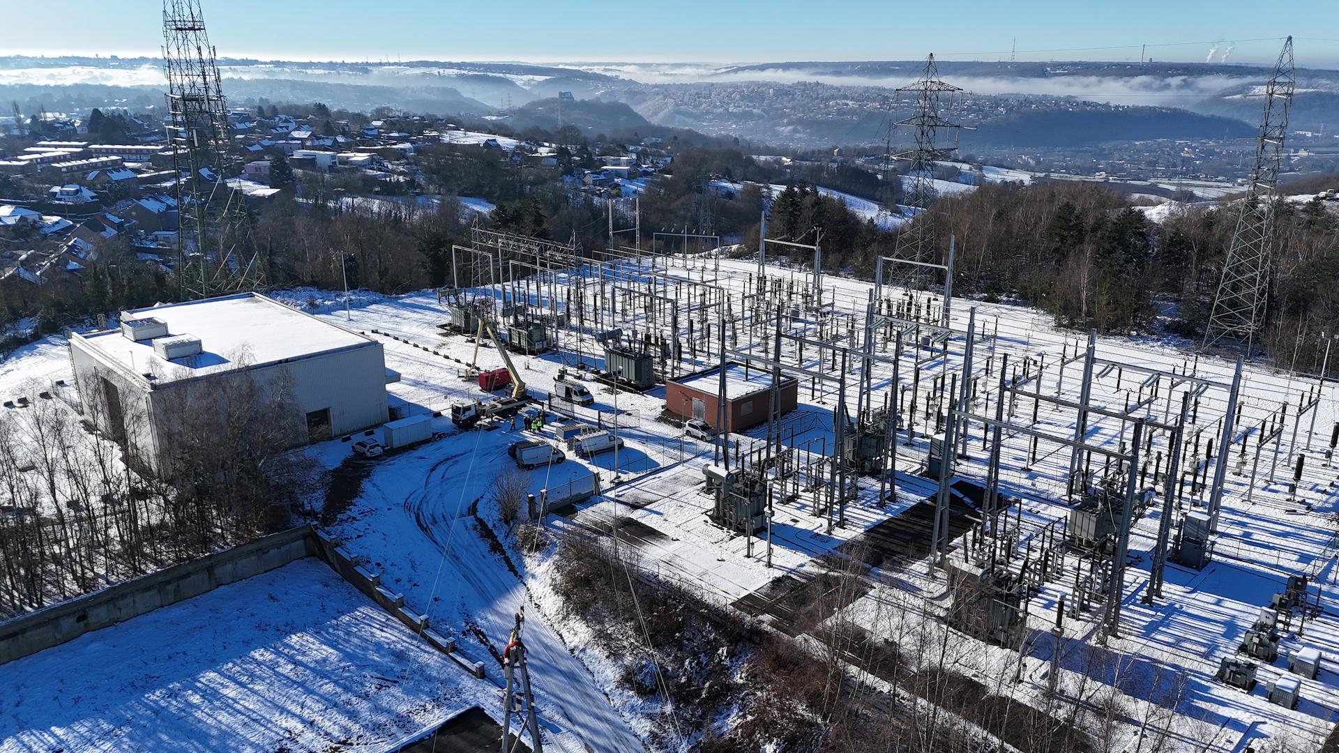 Aerial view of an electrical substation in a winter landscape supplying regional power distribution