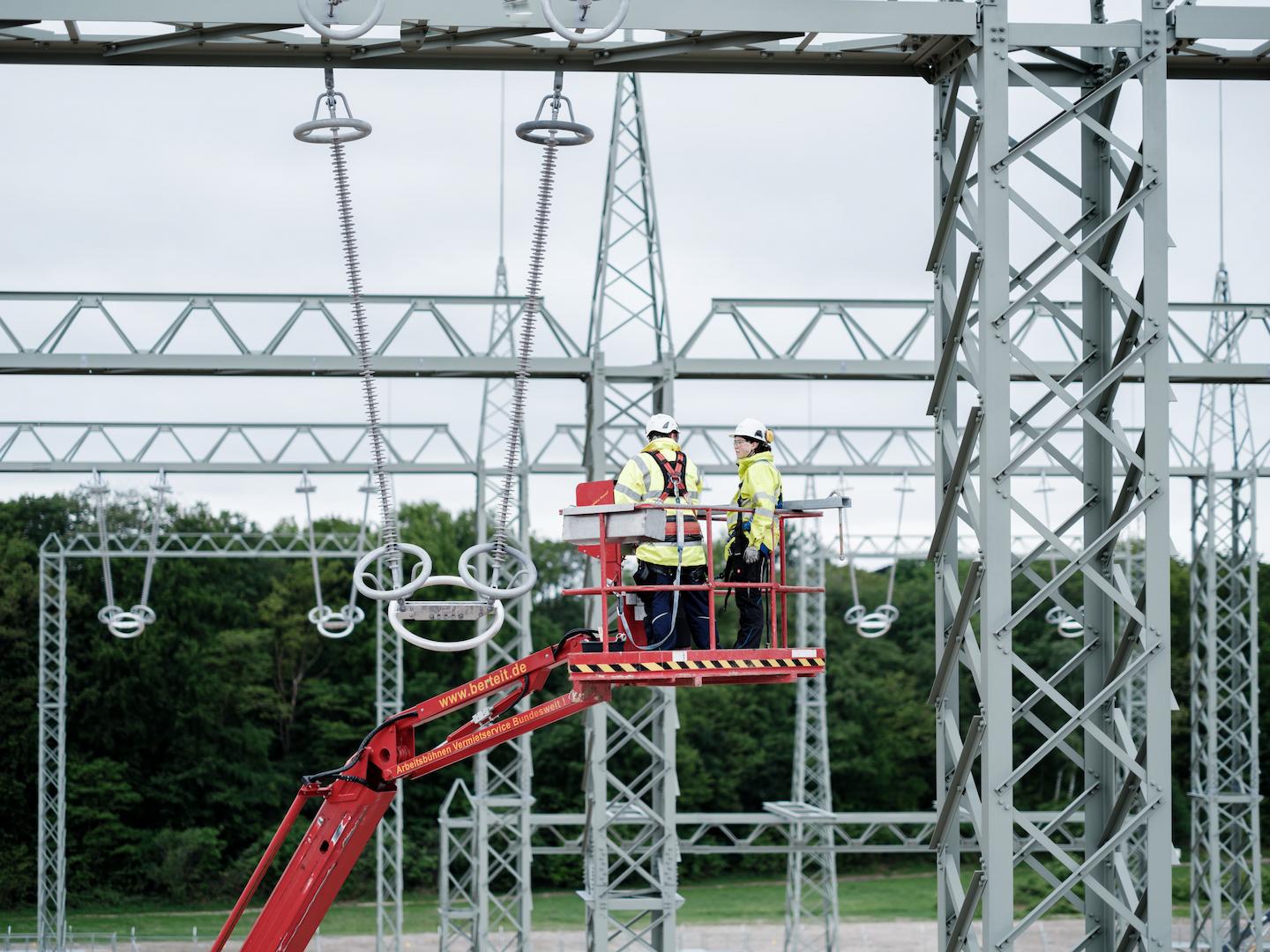 High-voltage substation equipment with overhead conductors and insulators during electrical grid installation
