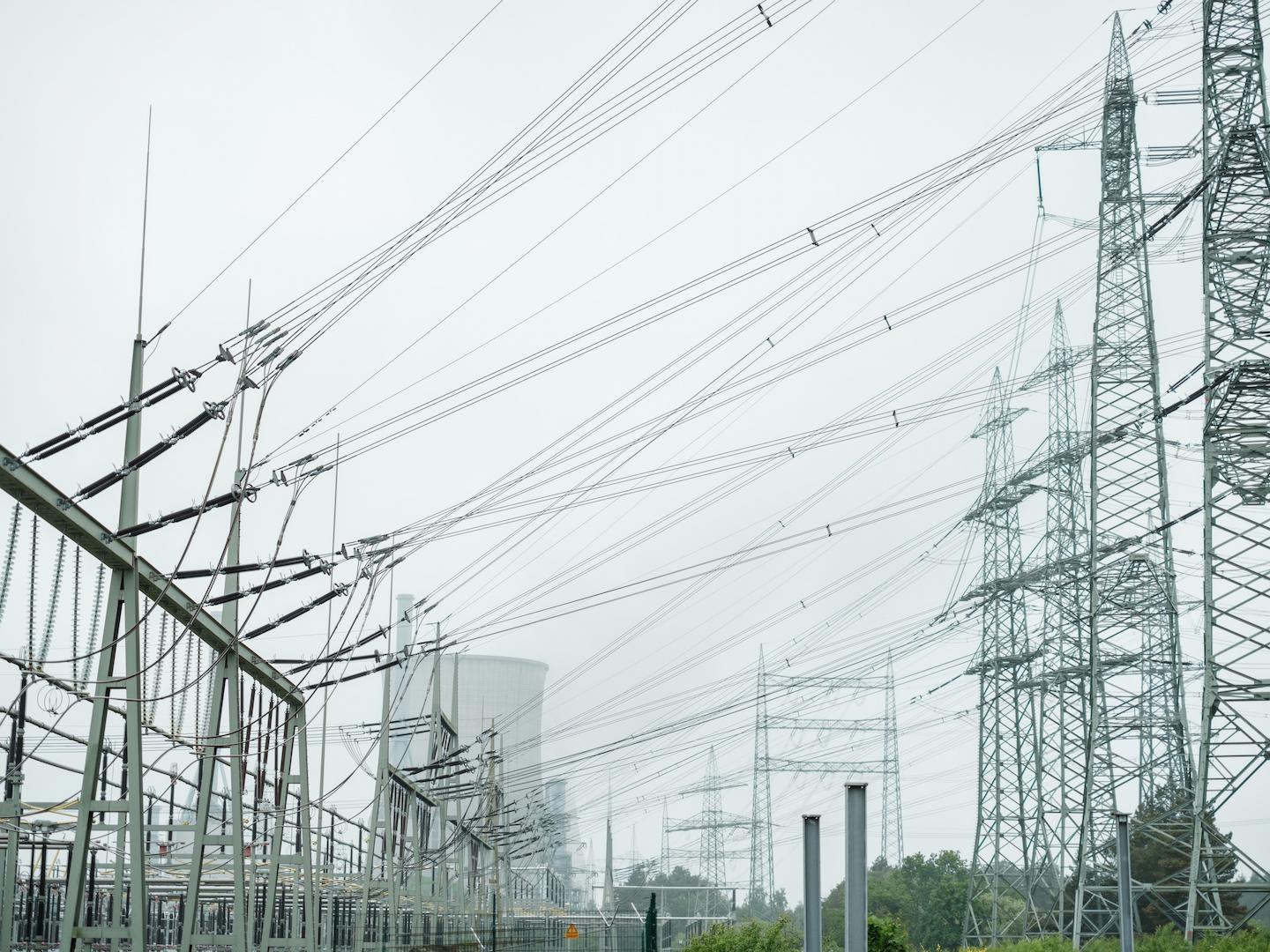 High-voltage power lines and transmission towers connected to an electrical substation