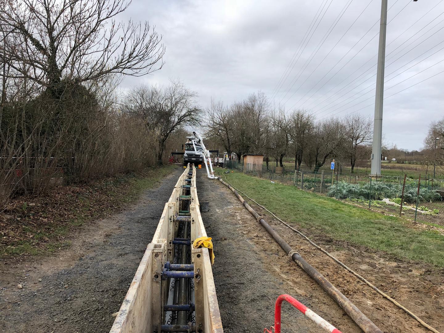 Underground power transmission infrastructure with reinforced trench and cable supports along a utility corridor