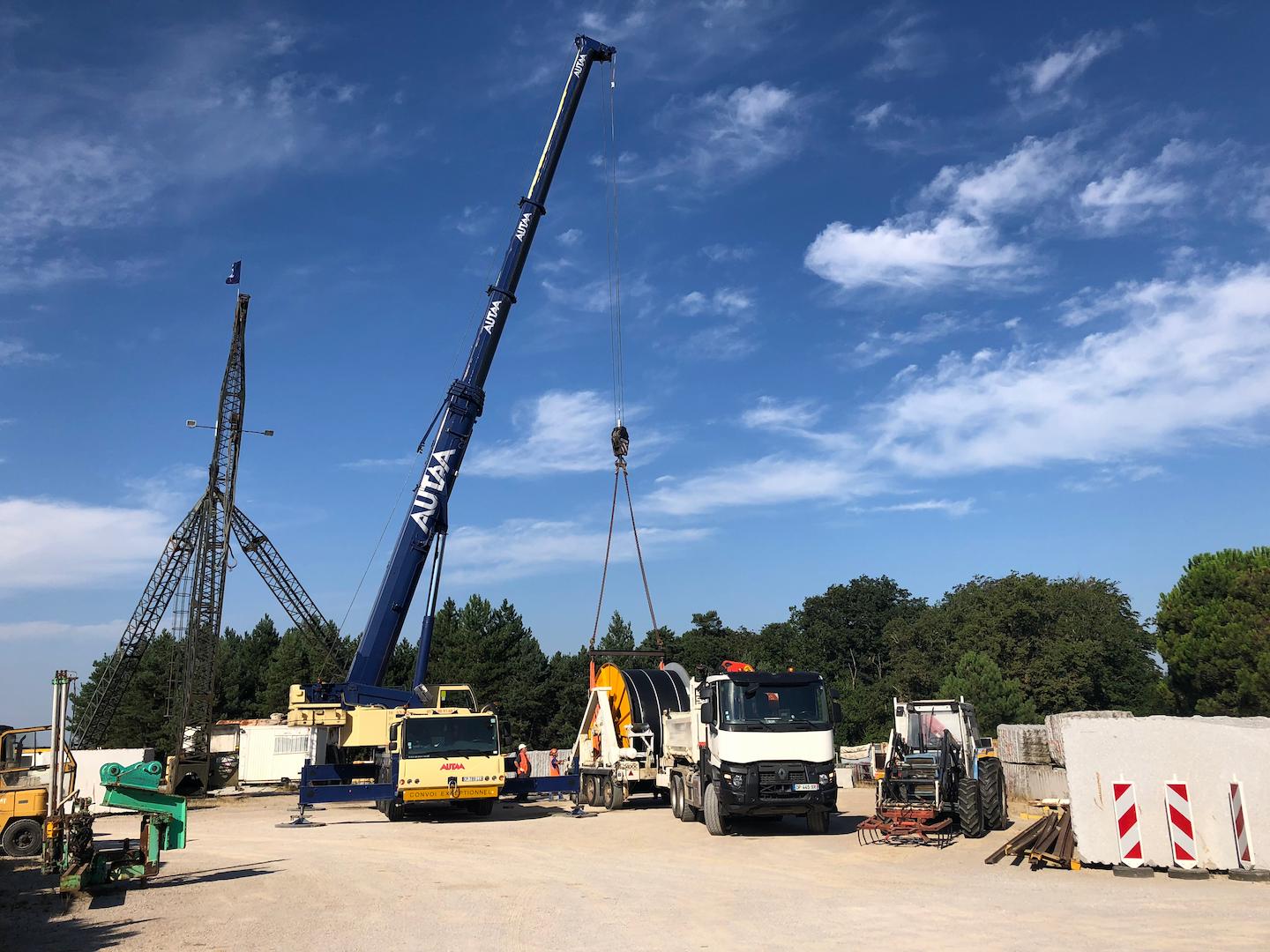 Construction site showing crane and heavy machinery used for underground electrical transmission installation