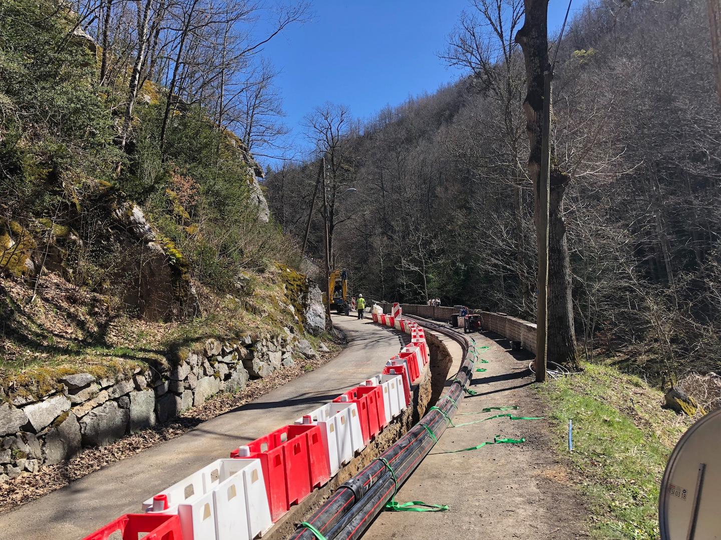 Underground power transmission works with cable trench installation along a rural access road