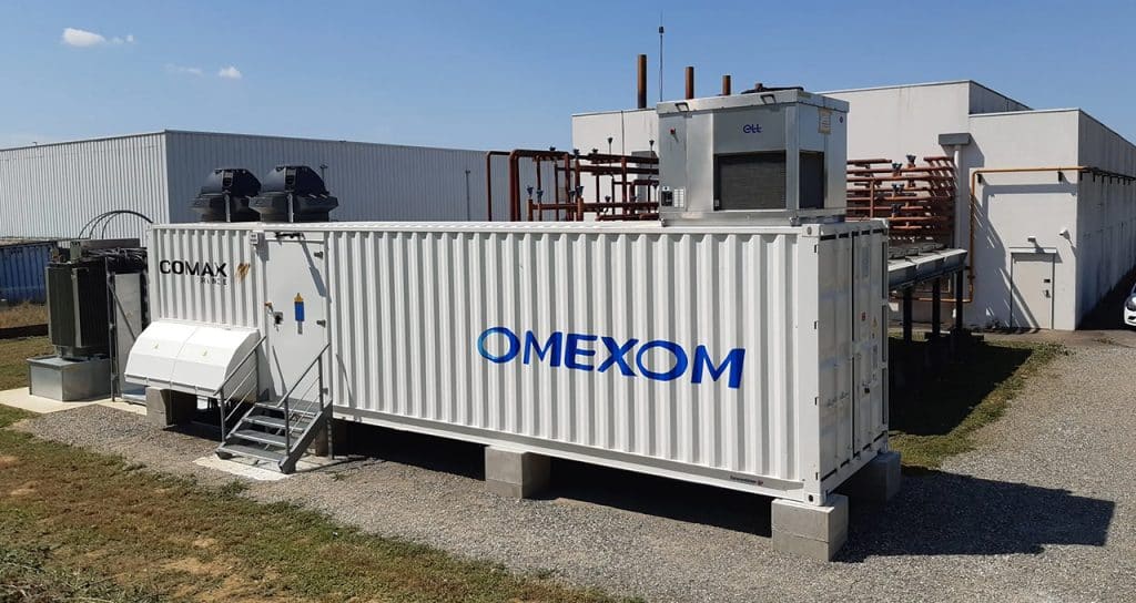 Containerized battery energy storage system (BESS) installed by Omexom at an industrial site, supporting reliable power distribution and critical electricity supply infrastructure
