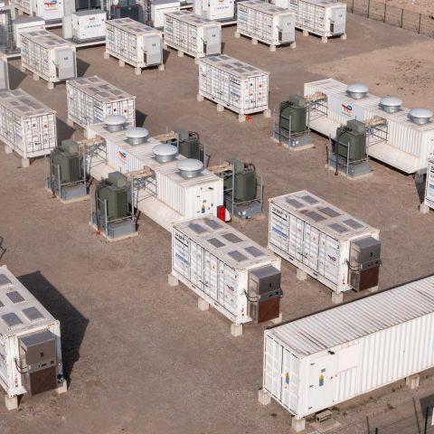 Aerial view of a large-scale battery energy storage system site with multiple containerized BESS units.