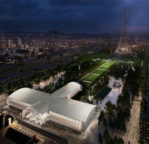 Night aerial view of Paris with the Grand Palais and Eiffel Tower area illuminated for major urban events