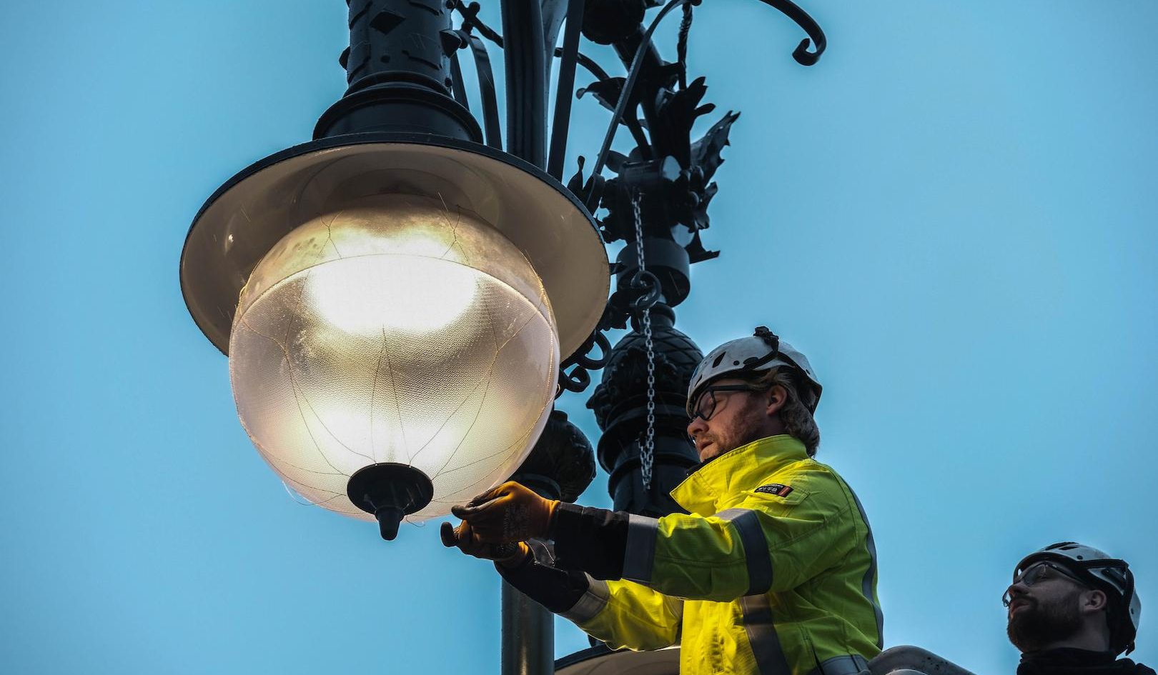 Technician maintaining modern public street lighting infrastructure to ensure reliable and energy-efficient urban illumination