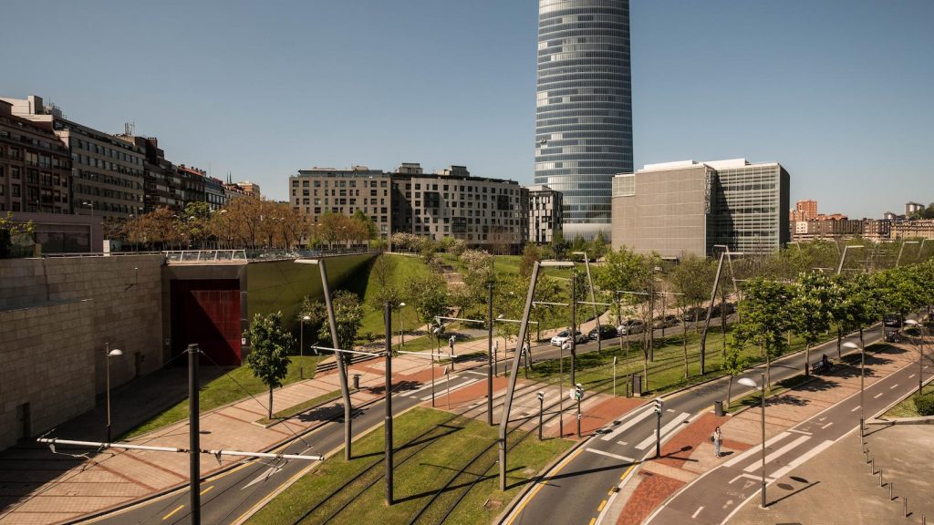 Modern urban district with integrated architectural lighting, showcasing sustainable city planning and illuminated public spaces