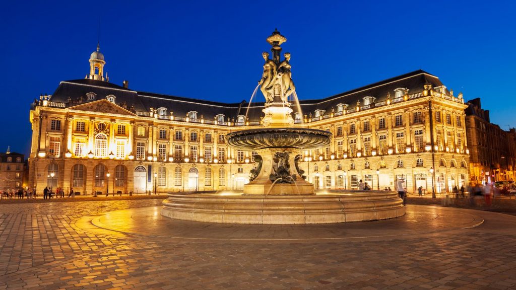 Historic city buildings illuminated at night with energy-efficient architectural lighting design