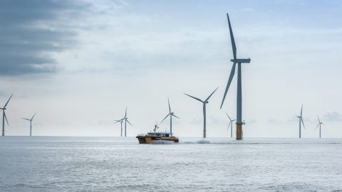 View of offshore windfarm and service boat