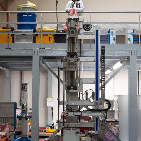Precision industrial machinery used for reactor component handling and mechanical testing in a nuclear facility