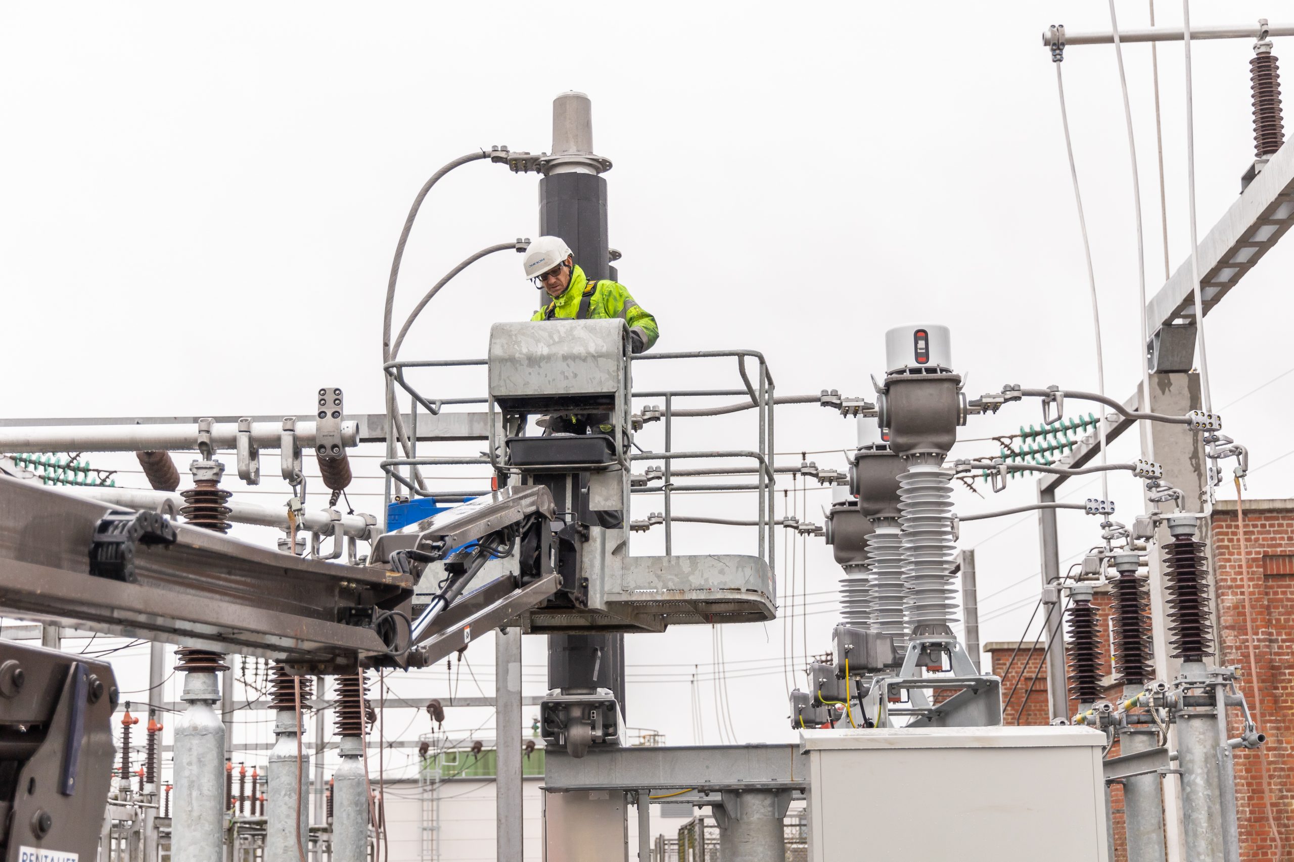 An Omexom employee working outside on the substation